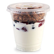 Plastic cup filled half way with vanilla yogurt and topped with fruit and granola